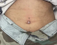 a woman with a tattoo on her stomach