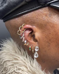 a man wearing a hat with ear cuffs
