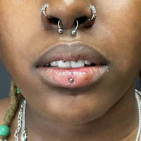 a woman with piercings on her nose